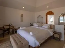 Relaxing bedroom with bed and ocean view.