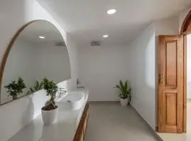 A modern bathroom with a sleek sink and a large mirror reflecting the clean and stylish design.