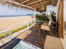 A stunning beach house with a wooden porch, offering breathtaking views of the vast and serene ocean.