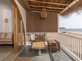 A cozy balcony with a wooden railing and a single chair, perfect for enjoying a peaceful moment outdoors.