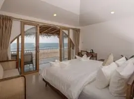 Relaxing bedroom with stunning ocean and beach view, perfect for unwinding.