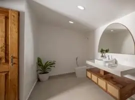 Bathroom interior featuring a sink, mirror, and toilet in a clean design.